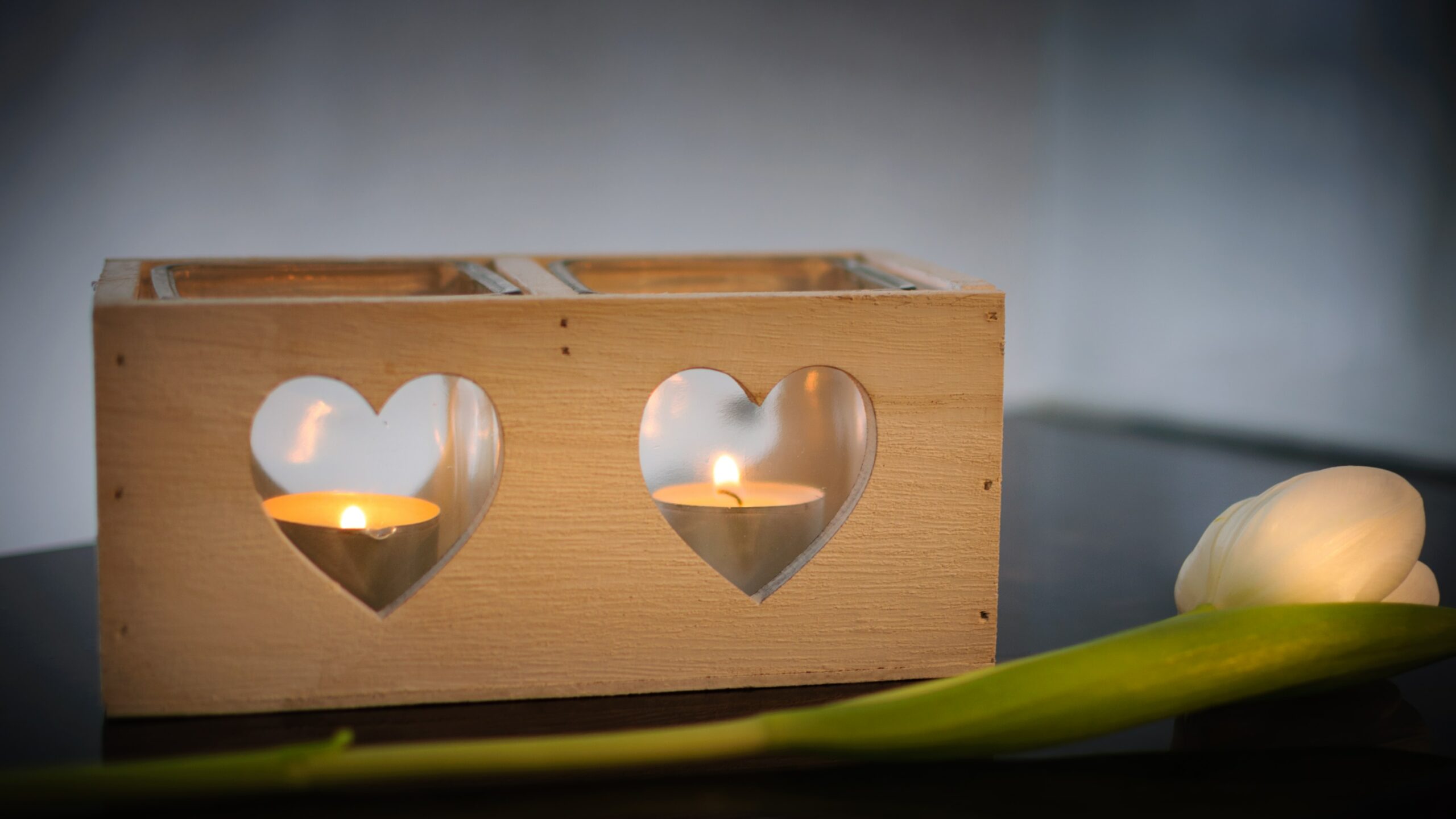 A box with heart-shaped holes and candles burning inside